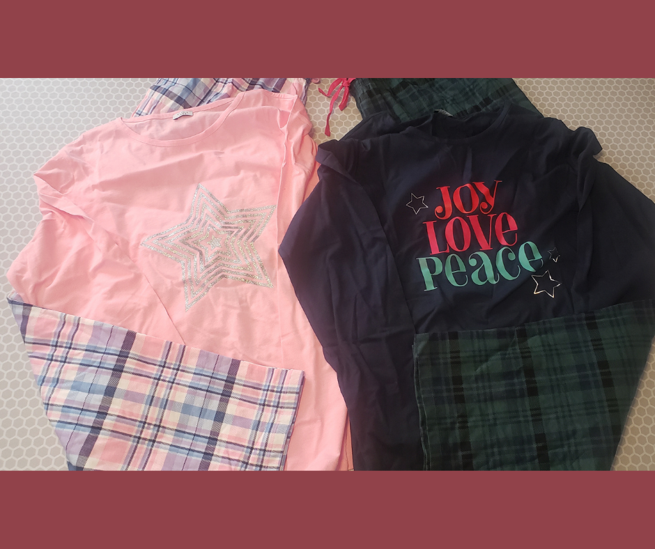 2 sets of pajamas, one with a light pink top with a silver star and pink and purple plaid pants, the other with the works Joy Love peace on a dark blue long sleeve shirt and green and blue plaid pants