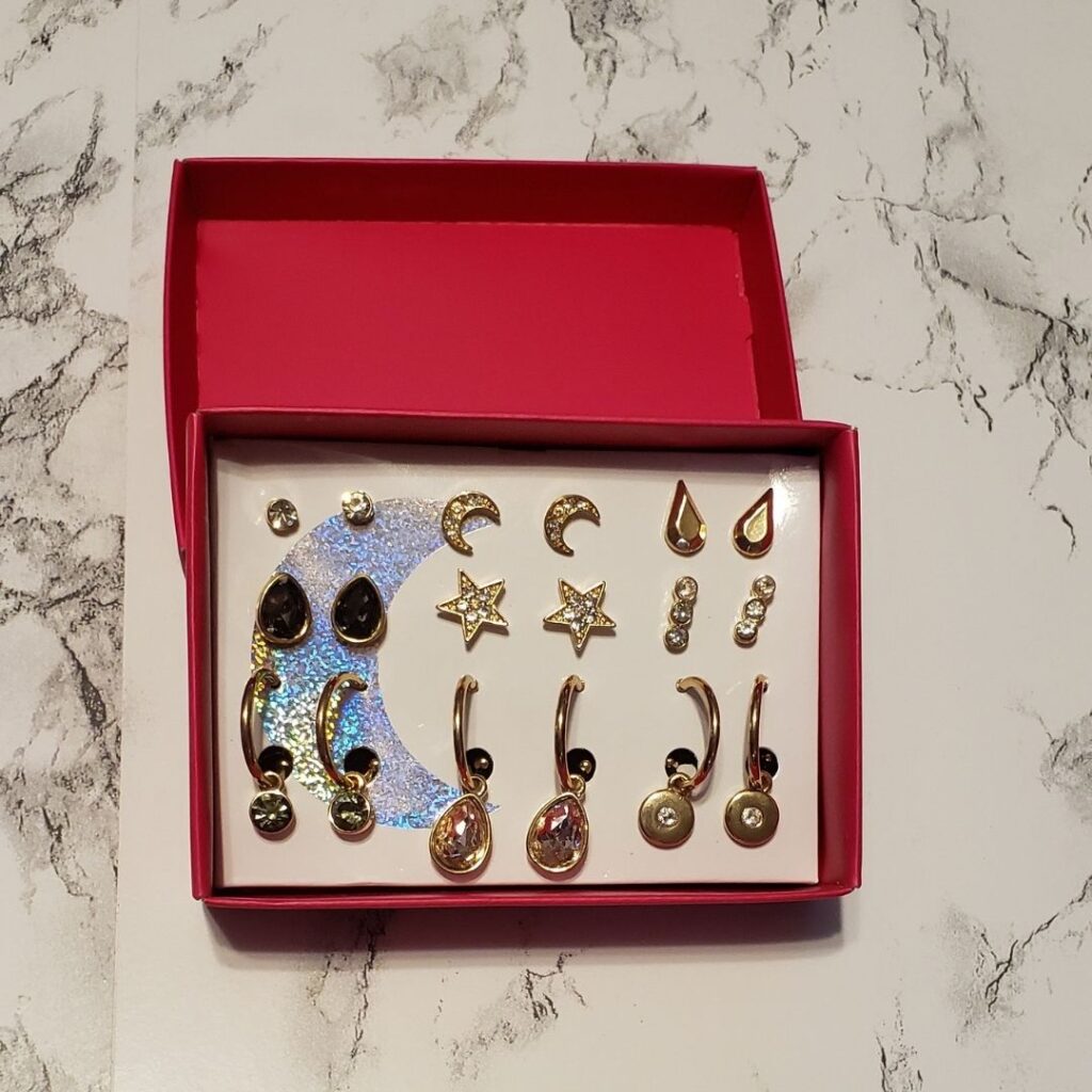 Set of earrings featuring post style and hoops with dangling charms 