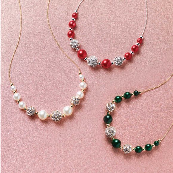 3 necklaces with sparkly and colored beads in ivorylike, red and green