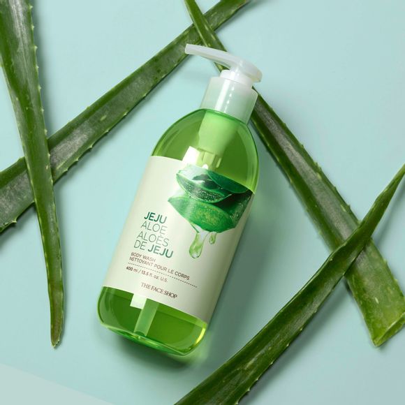 Jeju aloe body wash surrounded by whole aloe leaves