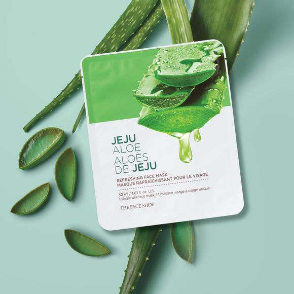 flat package with text: Jeju Aloe Refreshing Face Mask on top of aloe leaves