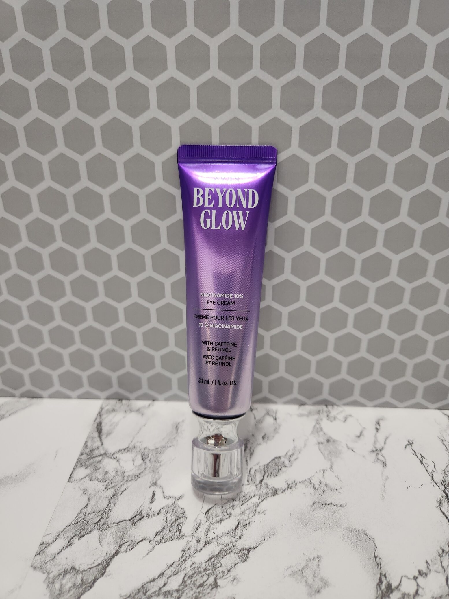 purple tube with clear cap and the words Beyond Glow Niacinamide 10% Eye Cream 