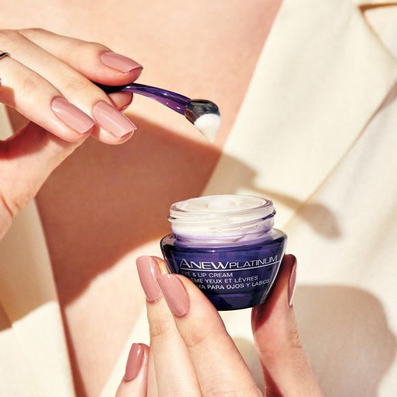 hands holding jar of Anew Platinum Eye & Lip Cream and applicator