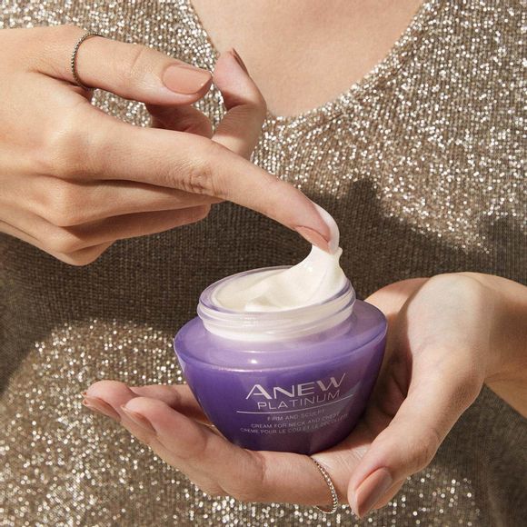 hands holding jar of Anew Platinum Firm and Sculpt Cream for Neck and Chest