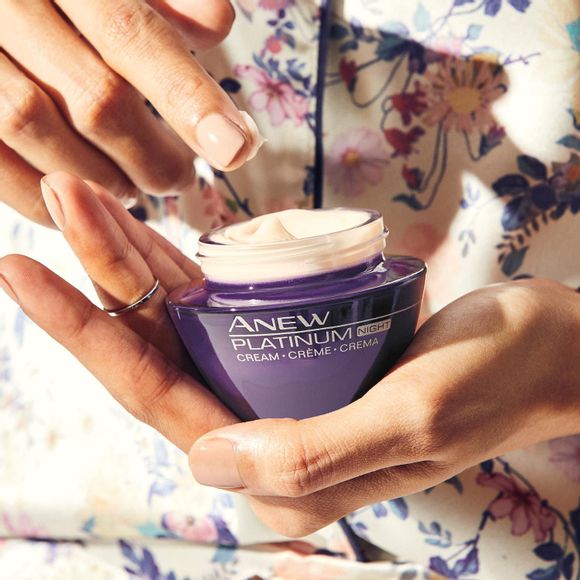 hands holding jar of Anew Platinum Night Cream